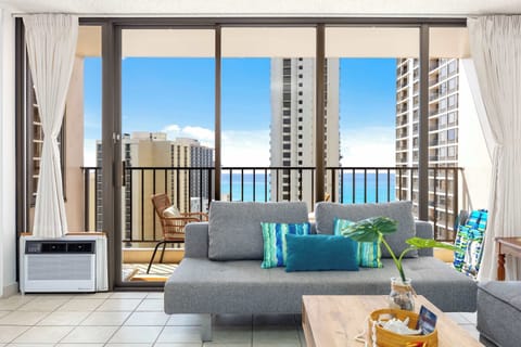 Settle in this cozy living space with two comfortable reclining sofas and an air conditioner, plus enjoy stunning city views from the balcony right next to your living room.