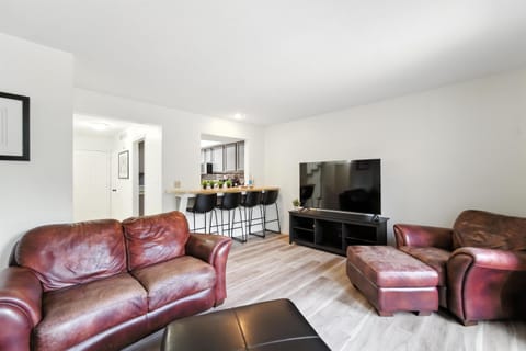 Comfy couches with a TV and access to the private deck.