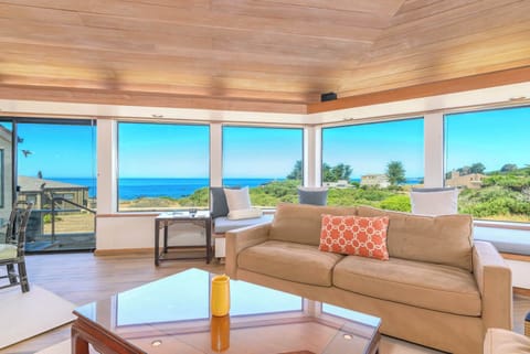 Relax in the bright and open living room, complete with cozy seating and coastal charm.