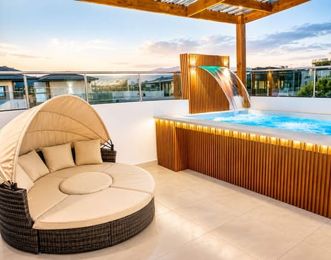 Unwind in your private rooftop jacuzzi with a cascading waterfall / cozy lounge