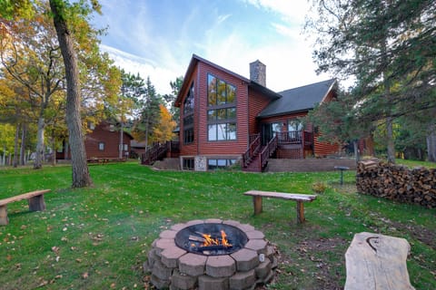 Spacious backyard with a firepit overlooking the lake.