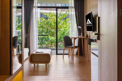 Cozy sitting area with flat-screen TV and branded details.