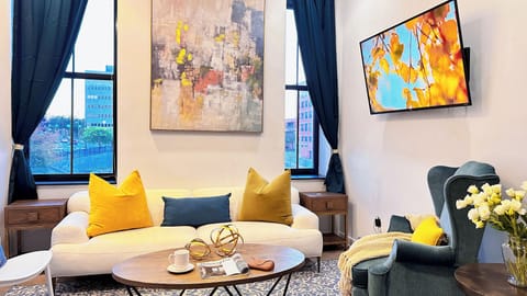 Large windows and curated art blend daylight with sophistication and style.
