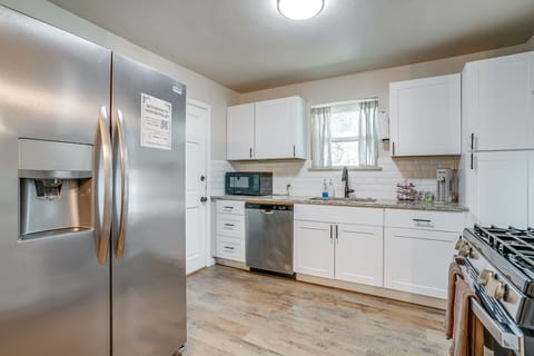Fully stocked kitchen with stainless steel fridge and everything you need