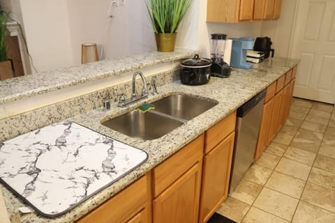 Spacious kitchen with dual sinks, ample counter space, and modern amenities, making it convenient for preparing meals during relocation or insurance stays.

