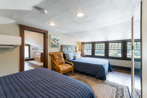 The third floor bedroom with two queen beds and an en suite bathroom. Note the lower ceiling height, I recommend another room for taller guests!