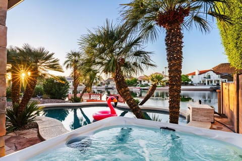 Hot tub with lake views beside the pool – relax and recharge