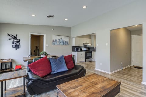 Bright living area with cozy sofa, TV & dining nearby.