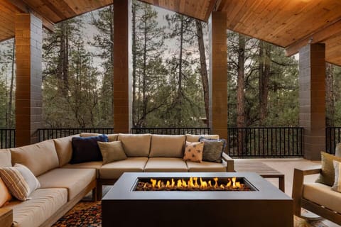 Huge deck with fire pit and outdoor sofa with forest views and elk passing by.