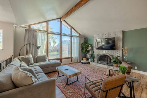 Vaulted ceiling and open living space with TV