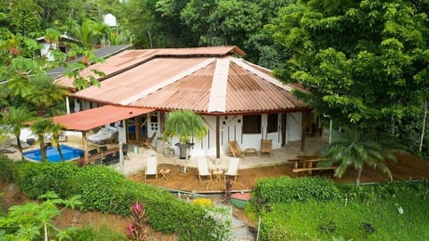 Our wooden deck with sunbeds, covered dining table, pool