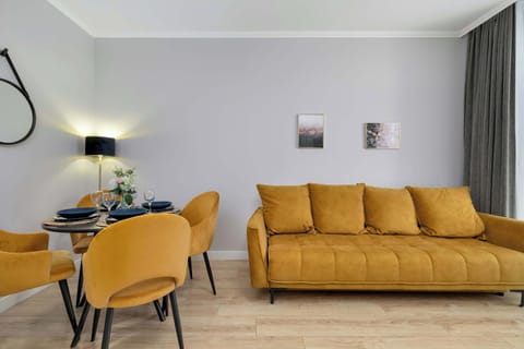 The elegant living room featuring a double sofa bed, perfect for relaxing or sleeping.