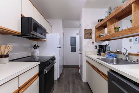 Well-equipped galley kitchen featuring sleek updated appliances