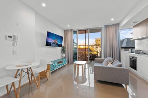 Bright lounge with sofa bed and Smart TV for easy South Brisbane downtime.