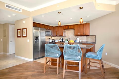 Gather around the breakfast bar in this spacious, open-concept kitchen—perfect for morning coffee or evening cocktails HKH-537
