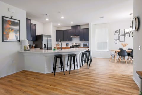 Fully equipped kitchen with sleek black cabinets and stainless steel appliances, ready for cooking or entertaining.