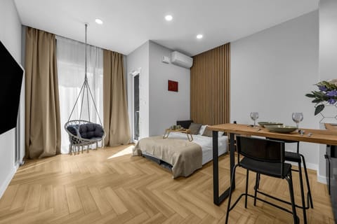 Main Living Area – Comfortable Double Bed, Smart TV, Dining Space and Unique Hanging Chair | Book Now with RENTUJEMY.COM