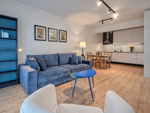 Modern Living Area with Spacious Sofa and Open Kitchen | Book Now with RENTUJEMY.COM