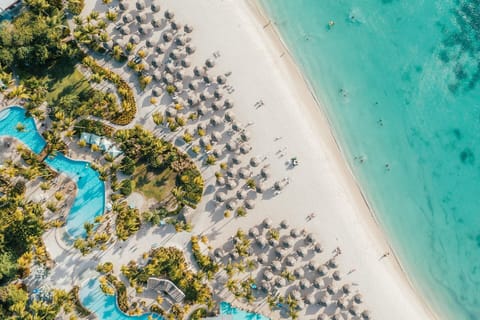 On the beach, white sand, beach cabanas, sun loungers