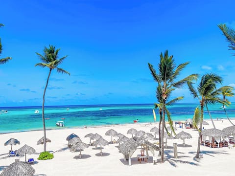 On the beach, white sand, sun loungers, beach umbrellas