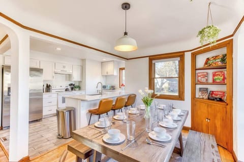 Large Wooden Dining Table, Adjacent to kitchen ideal for Gatherings of Up to 6 Guests.
