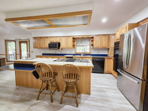 The large kitchen with central island is sure to be the hub of activity while you stay with us. Enjoy the beverage cooler to keep drinks cold and save on refrigerator space.