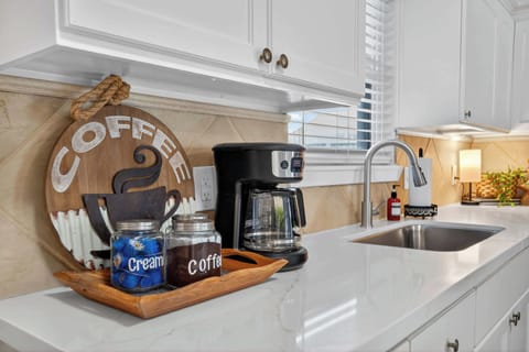 Kitchen: Brew your morning magic with style in this bright, inviting kitchen space.