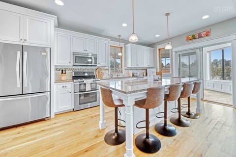 Kitchen with large island. Dining table is available on the 4 seasons porch. Update: It now has different chairs