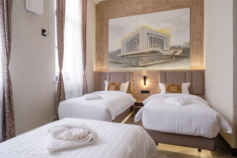 Standard Triple Room | Down comforters, desk, laptop workspace, blackout drapes