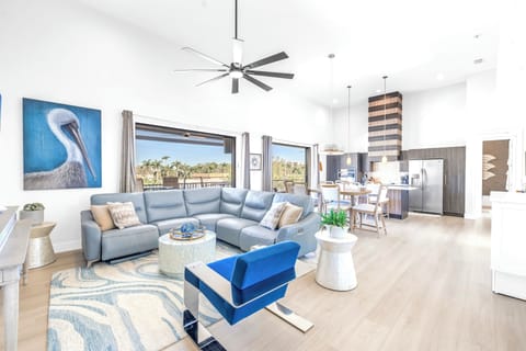 Living area spacious and sunny, open to private balcony with palm view.