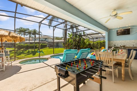 Covered Patio with Games – Enjoy outdoor dining, foosball, and poolside fun.