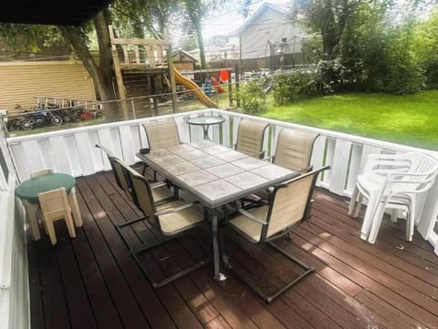 Private patio with 6-seat table, extra seating, and easy indoor access.