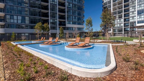 Resort-style outdoor pool with sun loungers