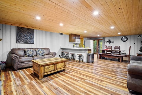 Downstairs Lounge | Fireplace, Bar Seating, and Rustic Cabin-Inspired Decor