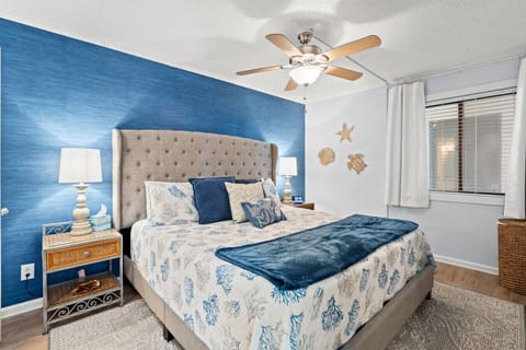 Spacious Myrtle Beach bedroom with a king-size bed, Smart TV, private full bathroom, and ample storage for longer stays. The perfect retreat to relax and rejuvenate during your North Myrtle Beach vacation rental getaway.