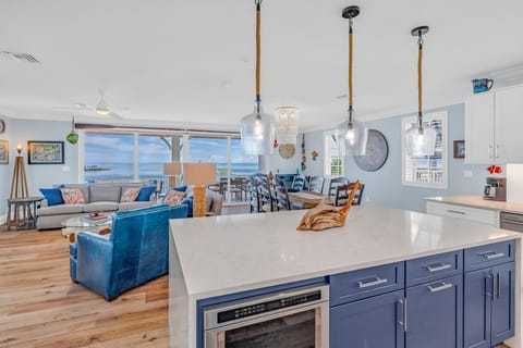Prepare gourmet meals in this fully equipped, modern kitchen featuring stainless steel appliances, island seating for four, and sweeping Gulf views. Perfect for family vacations or group retreats.