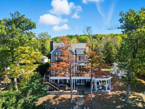 Lakeside exterior of the home with multiple decks and lake access.