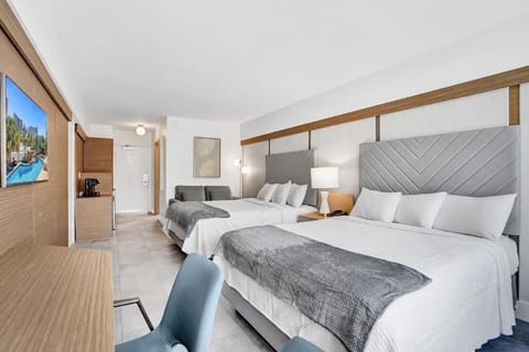 Recharge together in a bright double-queen room made for comfort.