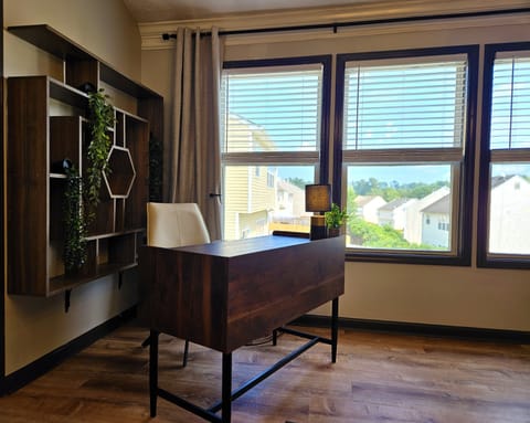 Stay productive on a dedicated workspace with a bright window view and comfortable desk setup. 