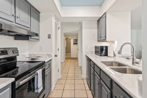 View from kitchen into entry way and other side ends with hall bath