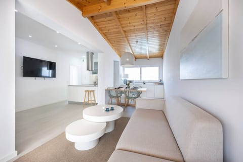 Spacious modernly furnished living room with view of kitchen and dining area