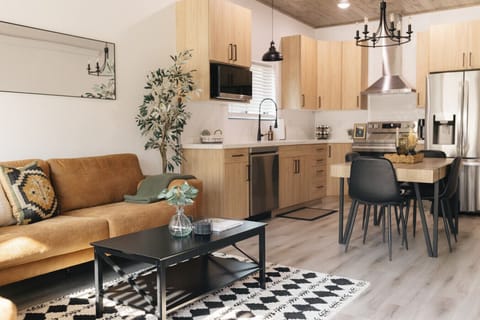 Living room with two large couches next to the kitchen.