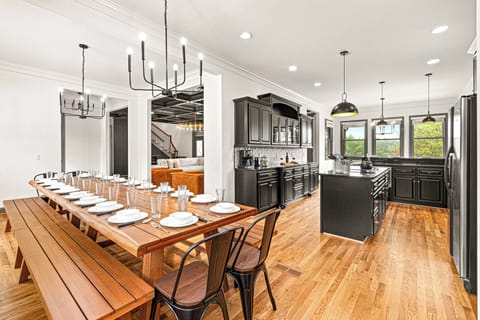 Modern dining area with long wooden table.