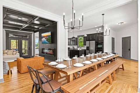 Spacious dining area with a long wooden table, perfect for large gatherings.