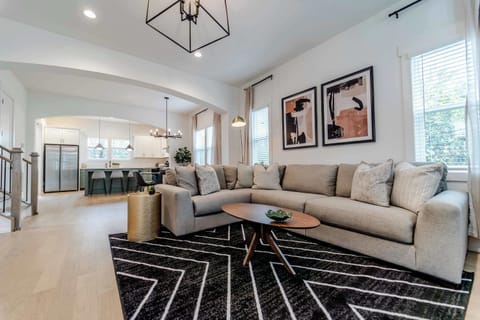 When you enter the house, you are greeted by an expansive living room with a large sectional couch and seating area as well as smart TV, perfect for movie nights or catching the big game.