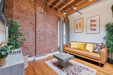 Cozy interior with exposed brick and tons of natural light with a skylight