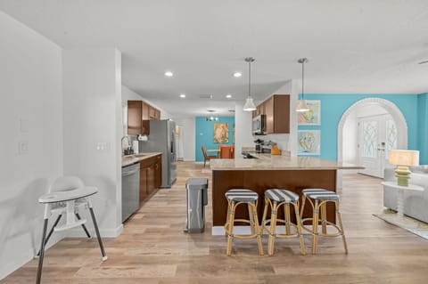 Cook, Connect, & Create Memories! This kitchen isn't just for cooking—it's for connecting! With an open layout that flows seamlessly into the lively living area, you'll never miss a moment of the fun. 