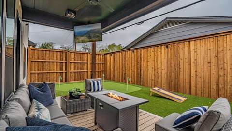 Host-worthy yard with putting green, cornhole, grill and lounge seating.