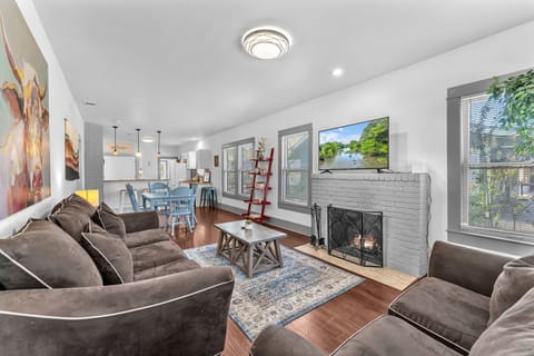 Bright living room with fireplace and cozy seating.