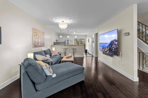 Cozy living area with stylish décor and a massive 86” 4K TV